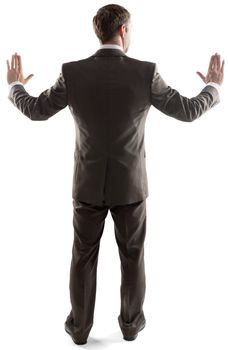 Rear view of young business man touching copy space isolated over white background