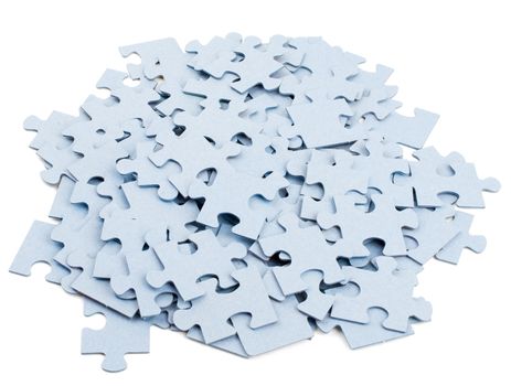 Pile of grey blank puzzle pieces isolated on white background
