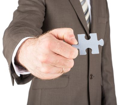 Businessman holding puzzle piece isolated on white background