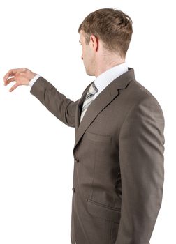 Man in suit reaching for something from above with empty copy space, successful man with idea grabbing something