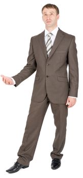 Handsome young businessman in classic suit keeping palm up and looking at camera on white background