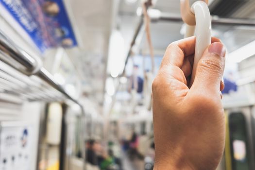 close up of hand holding Handles in Subway Train