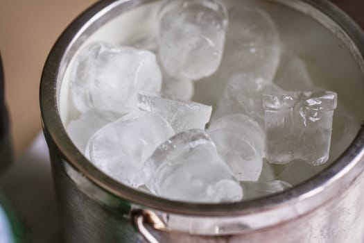 Bucket with cold ice cubes on the wedding 