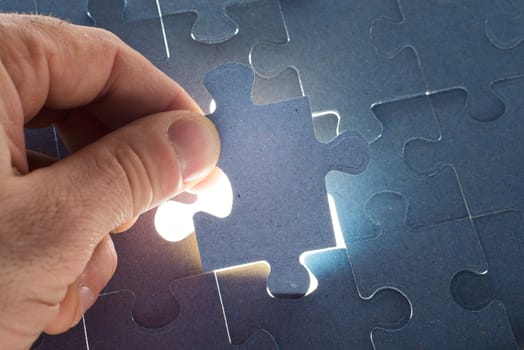 Man putting puzzle piece, close up view