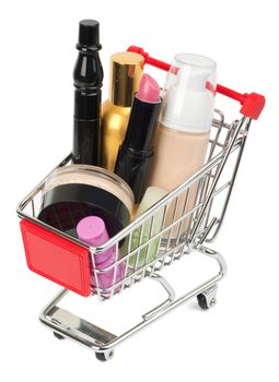 Set of cosmetics tubes in shopping cart isolated on white background, closeup