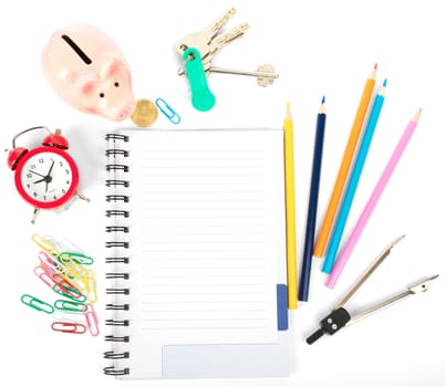 Open notebook with stationery and keys isolated white background, closeup