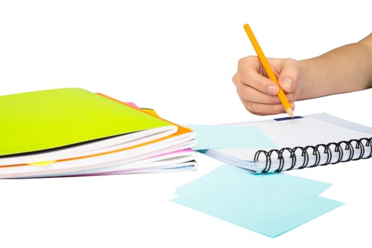 Females hand writing in notebook on isolated white background, closeup