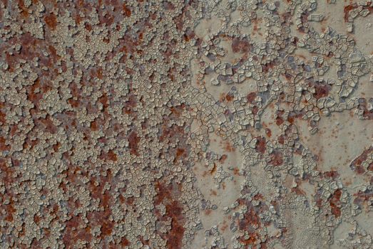 rusty iron surface covered with old chipped paint, which has long been influenced by different climatic conditions