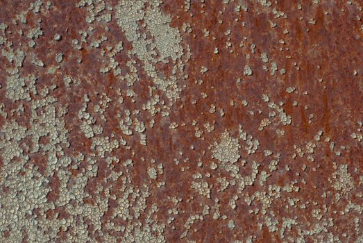 rusty iron surface covered with old chipped paint, which has long been influenced by different climatic conditions