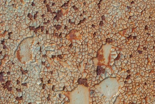 rusty iron surface covered with old chipped paint, which has long been influenced by different climatic conditions