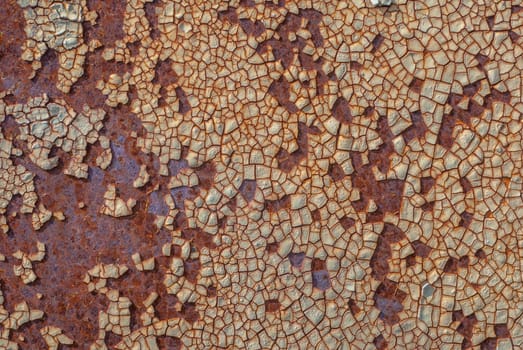 rusty iron surface covered with old chipped paint, which has long been influenced by different climatic conditions