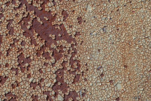 rusty iron surface covered with old chipped paint, which has long been influenced by different climatic conditions