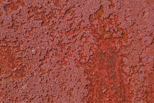 rusty iron surface covered with old chipped paint, which has long been influenced by different climatic conditions