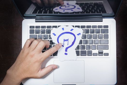 business, education, idea, inspiration and people concept - close up of male hands with paper sheet on computer keyboard