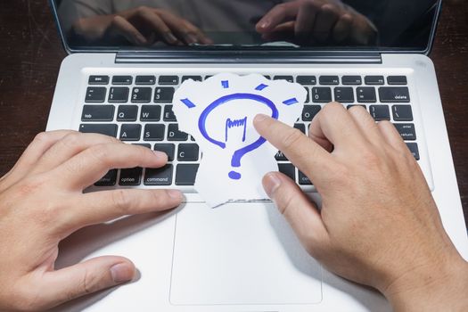 business, education, idea, inspiration and people concept - close up of male hands with paper sheet on computer keyboard