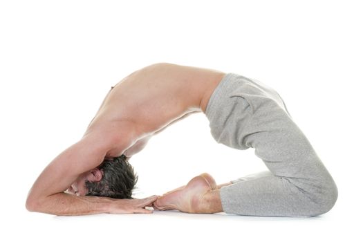 man doing yoga in front of white background