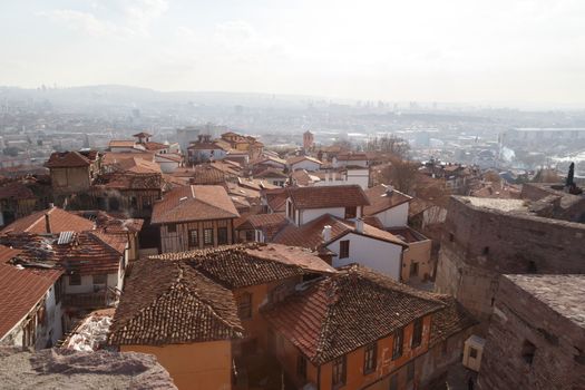 Cityscape view with old small houses from historical Ankara Tower on cloudy sky background.