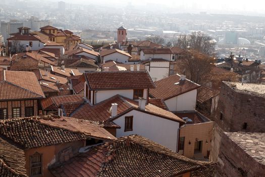 Cityscape view with old small houses from historical Ankara Tower on cloudy sky background.