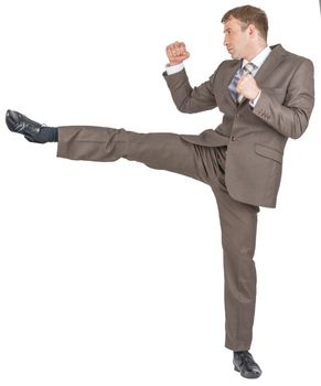 Angry businessman kicking isolated on white background