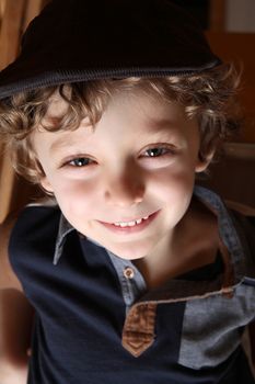 Young boy with curly blonde hair and blue shirt