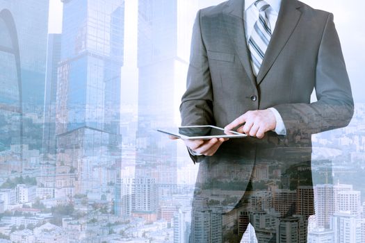 Businessman using tablet on urban city background