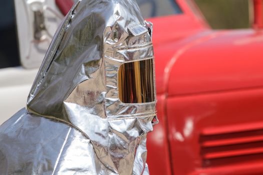 Fire in special heat resistant suit on a background of fire engine