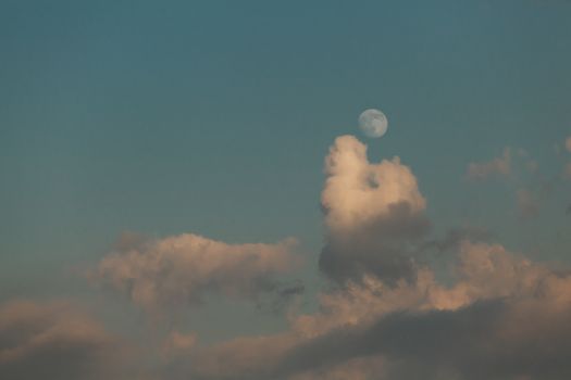 full moon in the background sunset, cloudy sky