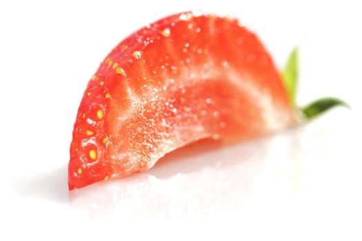 Quarter of Strawberry isolated over white.
Soft focus view.