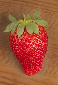 Ripe strawberrie over wooden table background 