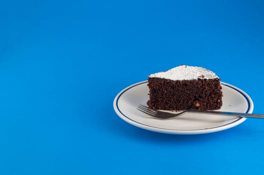 CLoseup of slice of chocolate cake  on colored background