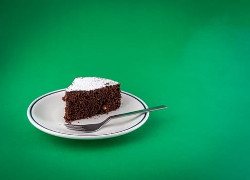 CLoseup of slice of chocolate cake  on colored background