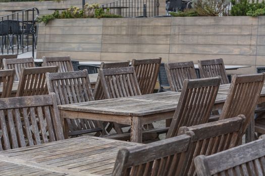 Beer garden wooden tables on the terrace of a restaurant.