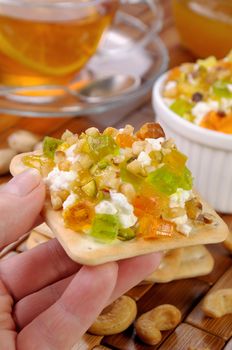 portion of cottage cheese with jam and marmalade, nuts on a cracker