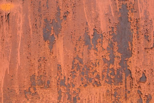 fragment of an iron surface is covered with red color paint, which has long been under the influence of different climatic conditions