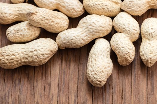 groundnut in the skin close-up on a wooden background