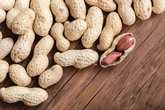 groundnut in the skin close-up on a wooden background