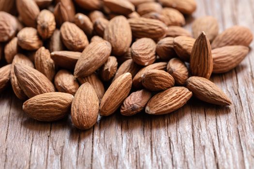 the natural almonds closeup on wooden background