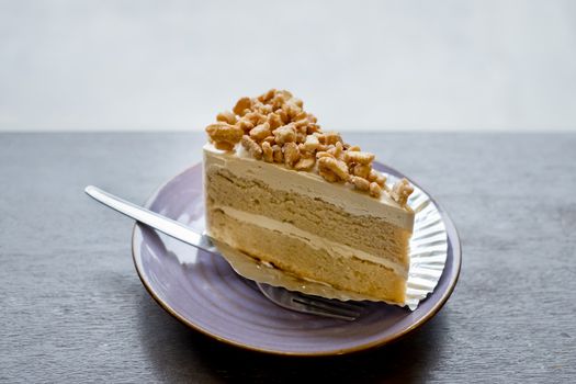 Piece of Coffee Cake with slice nuts topping.