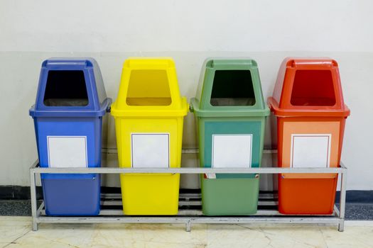 Different Colored wheelie bins set with waste icon