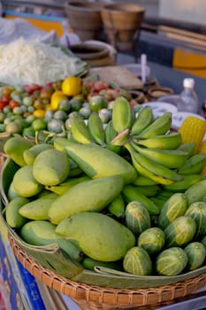 Green color of fruits and cucumber in a basket