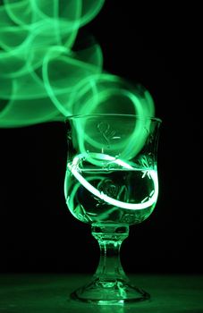 A neon glowing party drink illuminated in the nightclub.