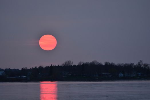 Red sunset over northern lake