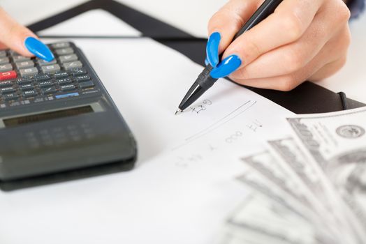 Woman hand working economic report. Close-up