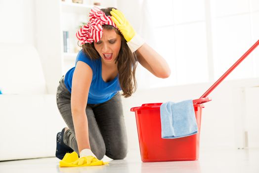Young beautiful woman scrubing floor