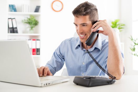 Beautiful young Businessman telephoning and working in the office.