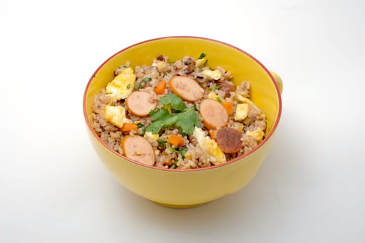 Fried rice with sausage and vegetables on white background