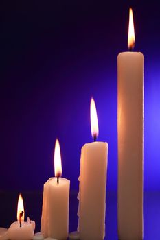 Set of lighting candles on nice dark background