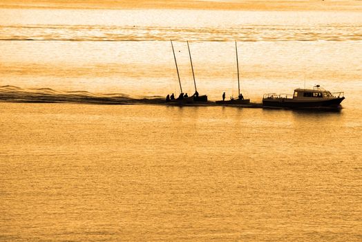 boats being towed in cobh ireland at sunset