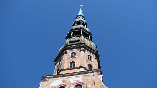 White church spire against blue sky