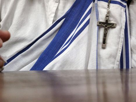 The white sari with blue stripes and a crucifix are recognizable sign of the Missionaries of Charity, Kolkata, West Bengal, India on January 27, 2009.